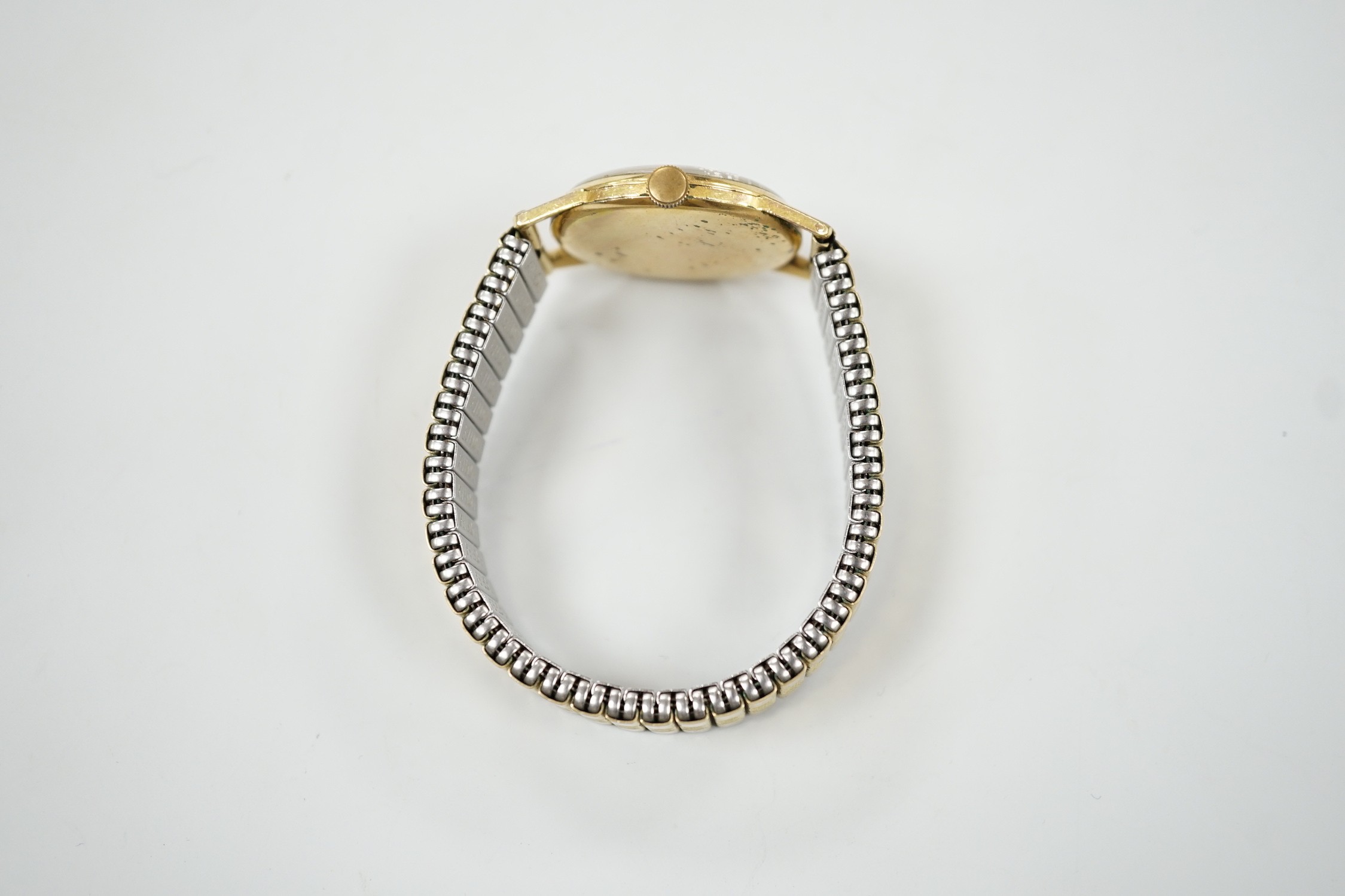 A gentleman's gold plated Olma manual wind wrist watch, case diameter 32mm, on associated flexible bracelet.